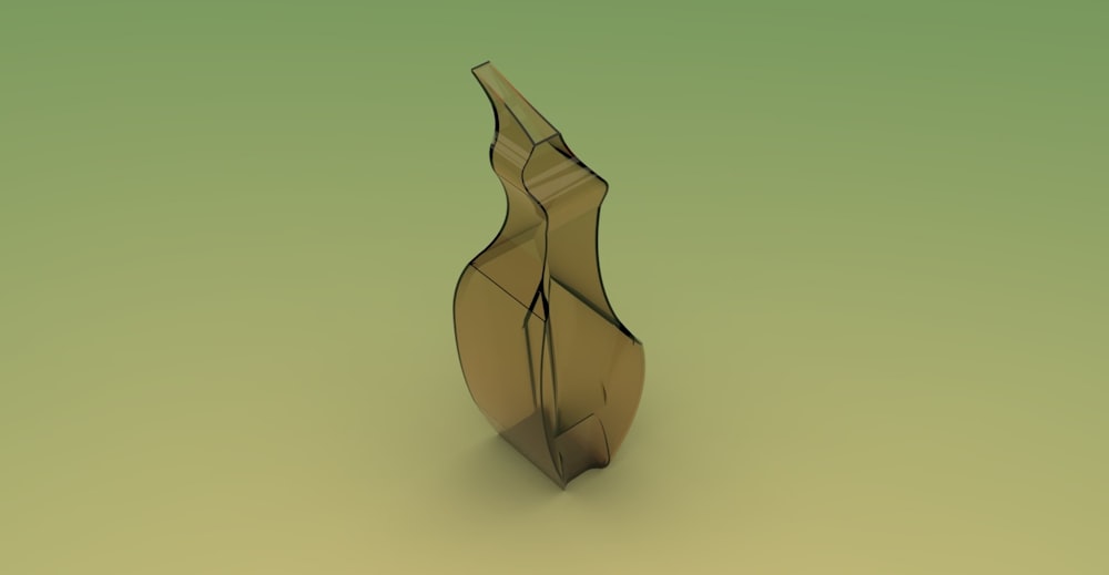 a glass vase sitting on top of a green surface