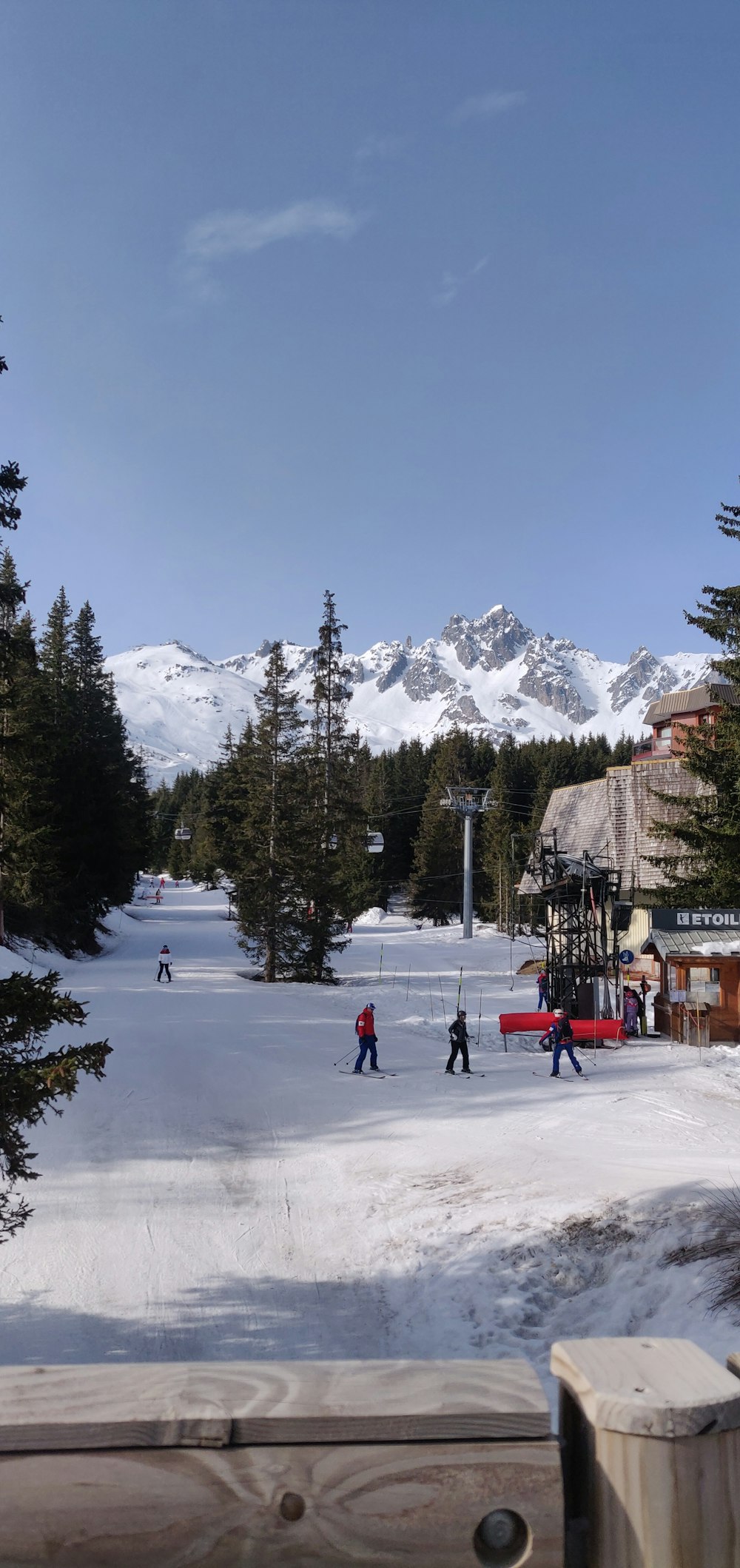 a group of people riding skis down a snow covered slope