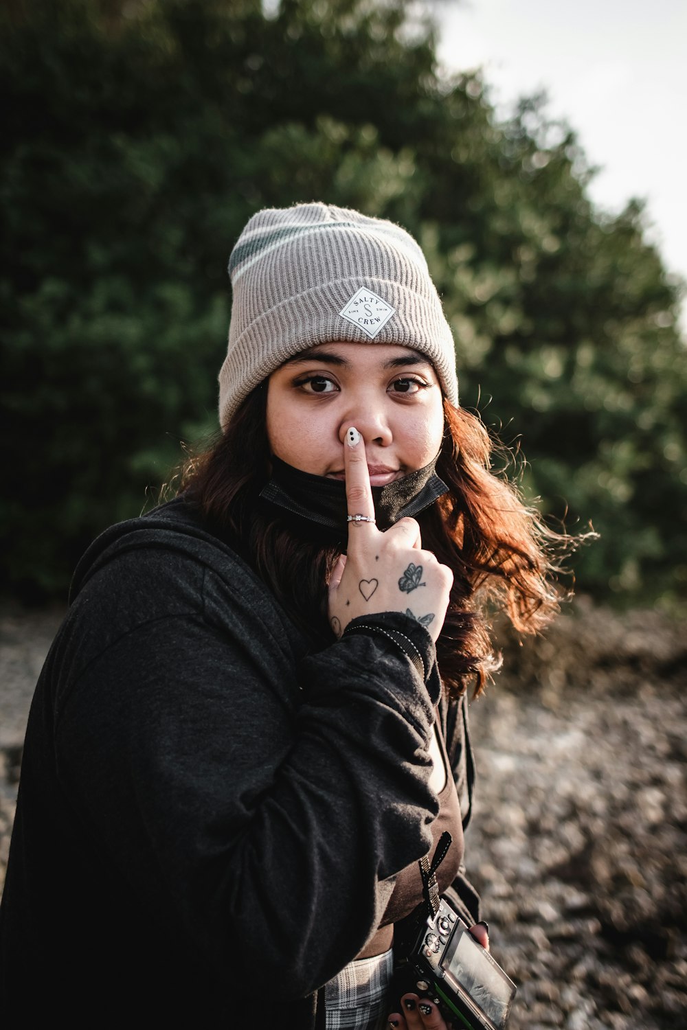 a woman with a finger on her nose