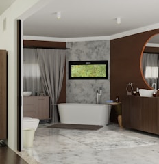 A modern bathroom featuring a free-standing bathtub against a textured wall with a narrow horizontal window above it. There is a large circular mirror above a wooden vanity, complemented by a minimalist sink and faucet design. Neutral colors dominate the room, with accents of brown and gray. A soft rug is placed on the tiled floor, adding warmth to the space. Elegant drapes frame a side window, softening the overall atmosphere.