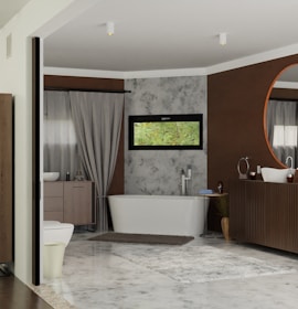 A modern bathroom featuring a free-standing bathtub against a textured wall with a narrow horizontal window above it. There is a large circular mirror above a wooden vanity, complemented by a minimalist sink and faucet design. Neutral colors dominate the room, with accents of brown and gray. A soft rug is placed on the tiled floor, adding warmth to the space. Elegant drapes frame a side window, softening the overall atmosphere.