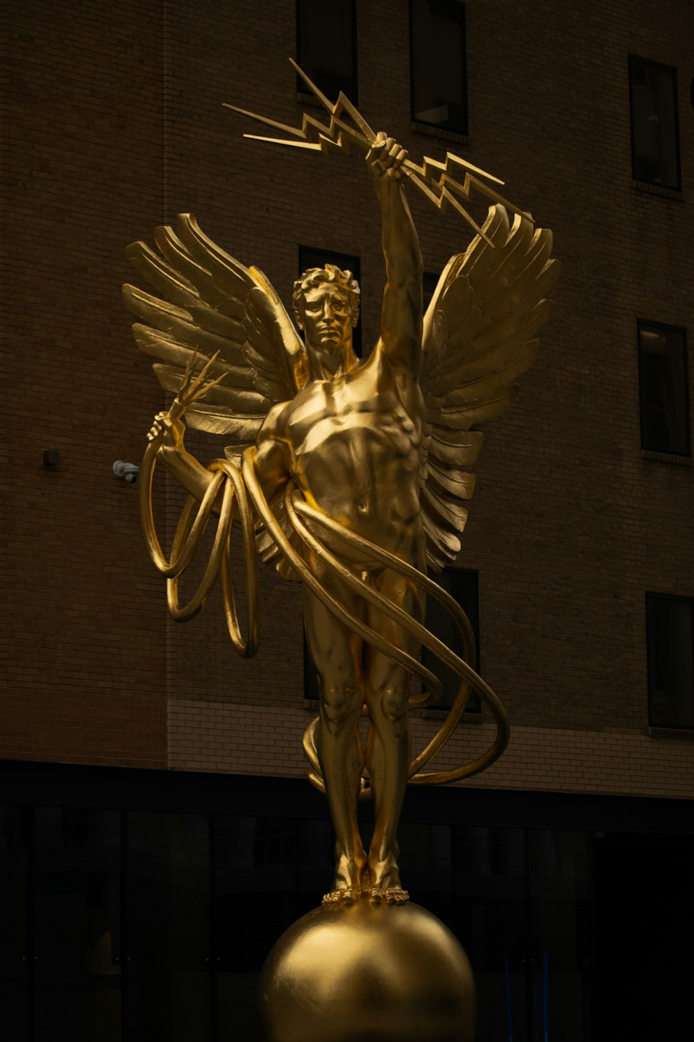 a golden statue of an angel holding a bow