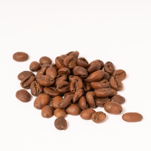 A close-up of coffee beans scattered on a surface.