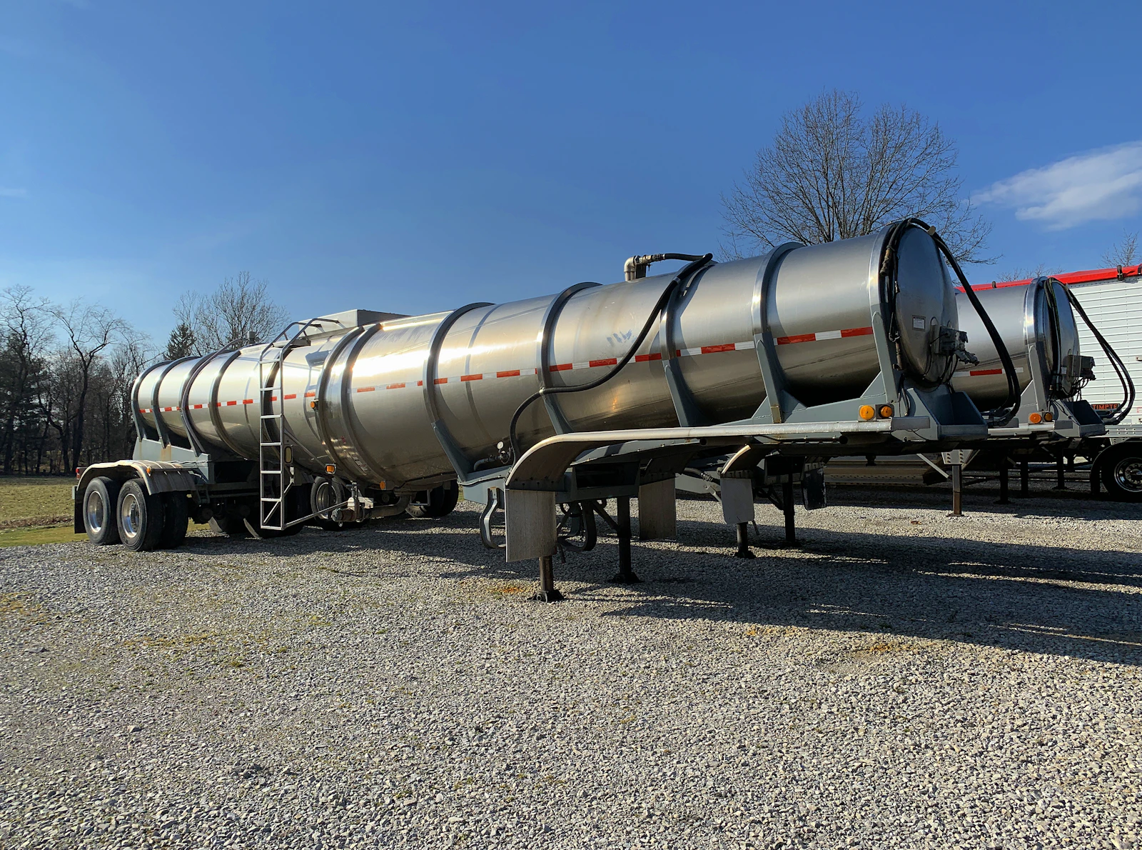 Stainless tanker trailer on a gravel yard