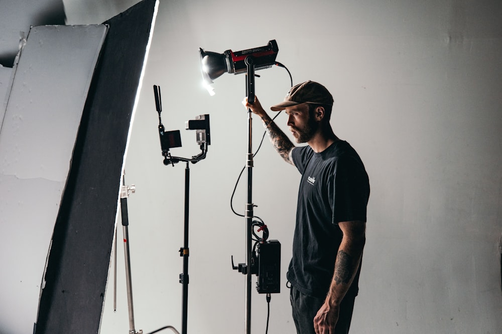 a man standing in front of a camera and lighting equipment