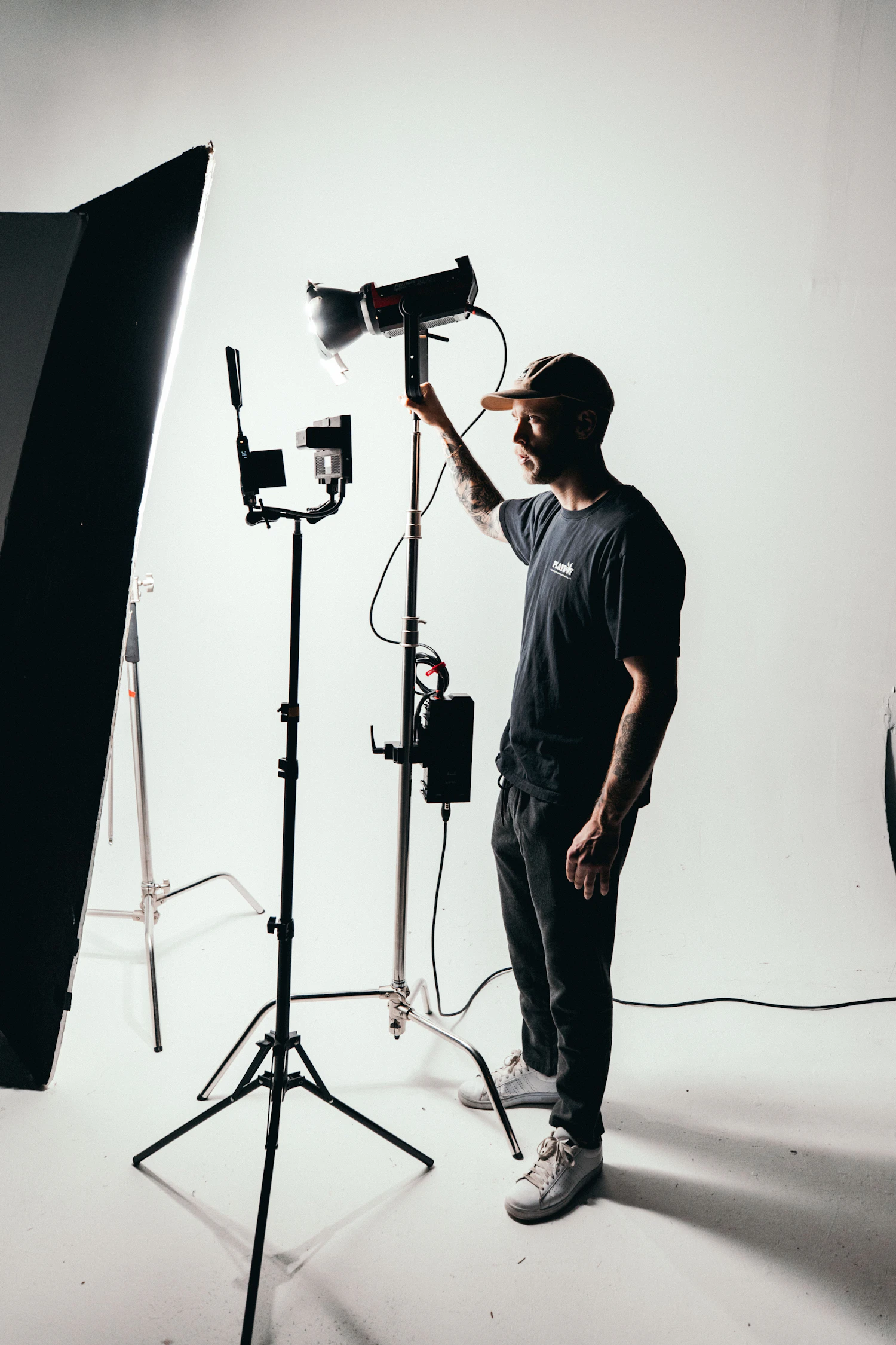 A photographer preparing a camera in a professional studio