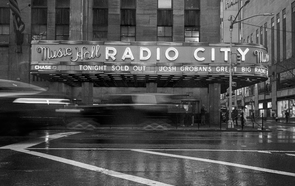 a black and white photo of a radio city sign
