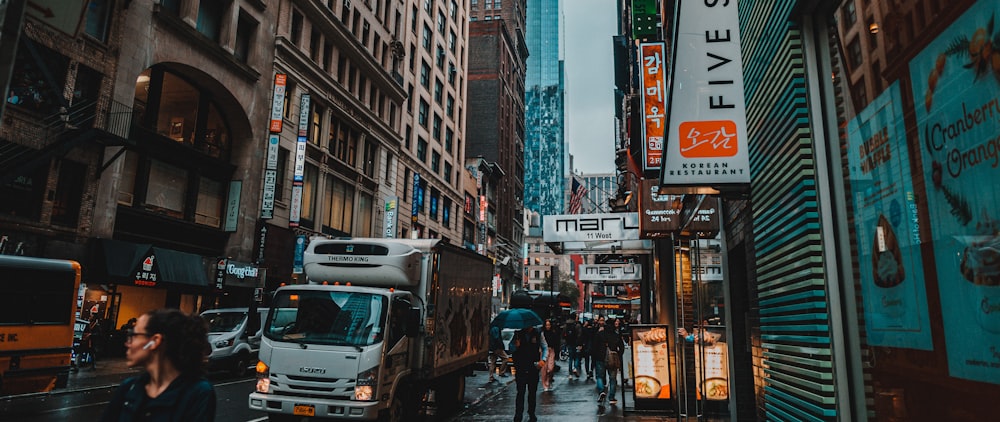 a busy city street with people walking on the sidewalk