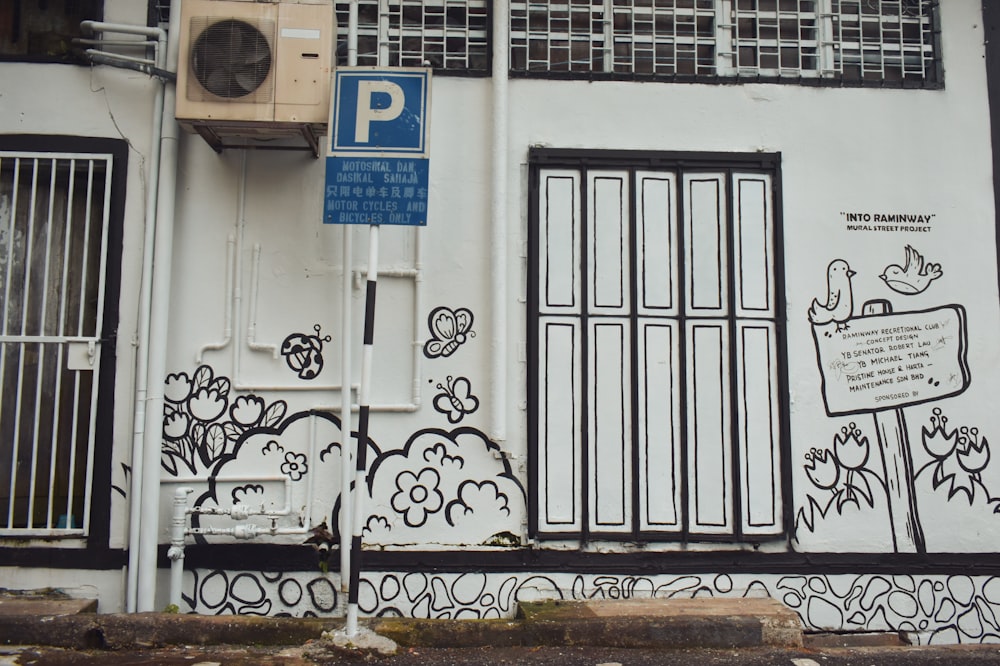 a white building with black and white graffiti on it