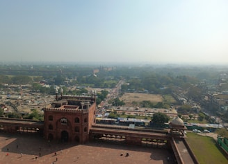 An aerial shot of a historic fort surrounded by mountains.