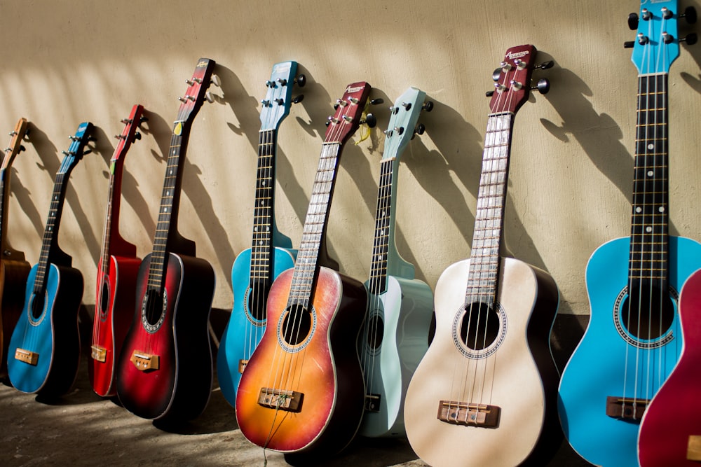a row of guitars lined up against a wall