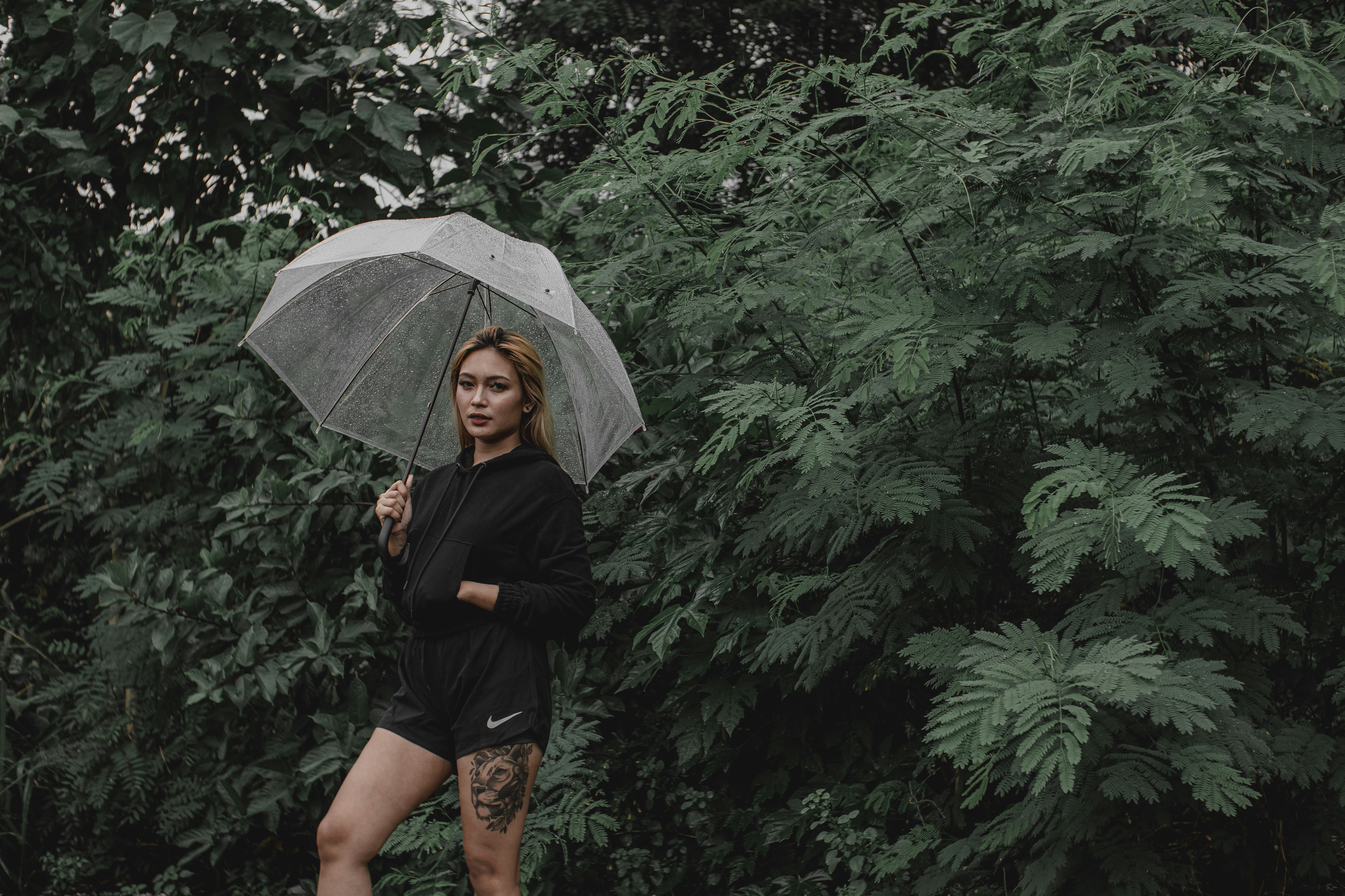 Eine Frau, die mit einem Regenschirm im Regen spazieren geht Foto –  Kostenloses Bild zum Thema Mädchen auf Unsplash, image size:3000x2000