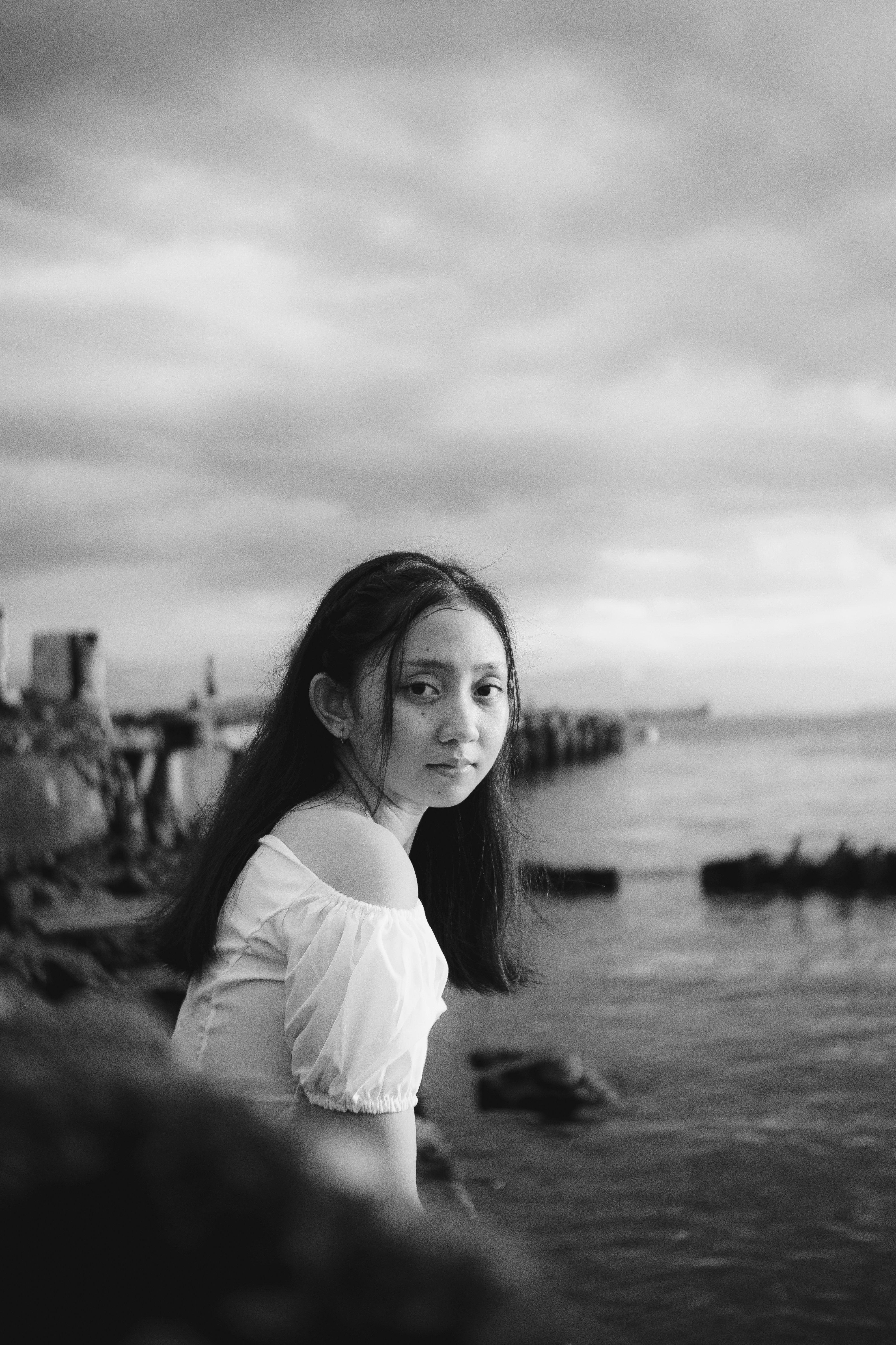A woman standing next to a body of water photo – Free Grey Image on ...