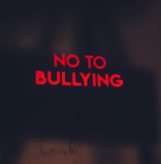 a red sign that says no to bullying