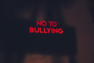 a red sign that says no to bullying