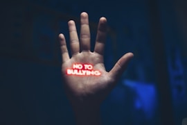 a hand with the word no to bullying written on it