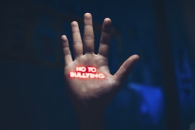 a hand with the word no to bullying written on it