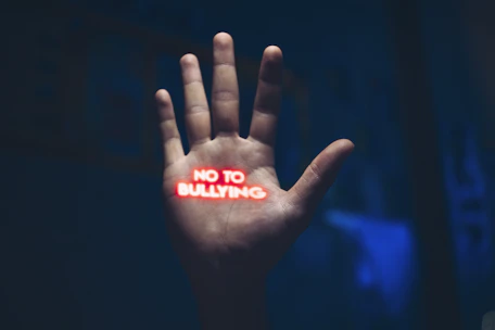 a hand with the word no to bullying written on it
