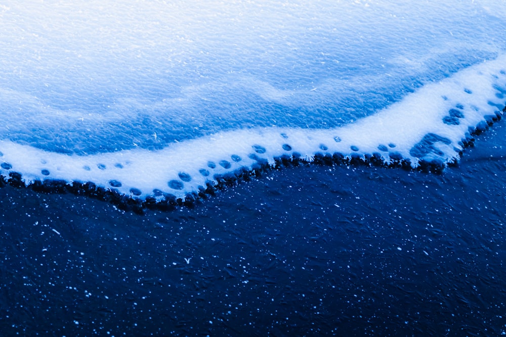 a close up of snow on a surface of water