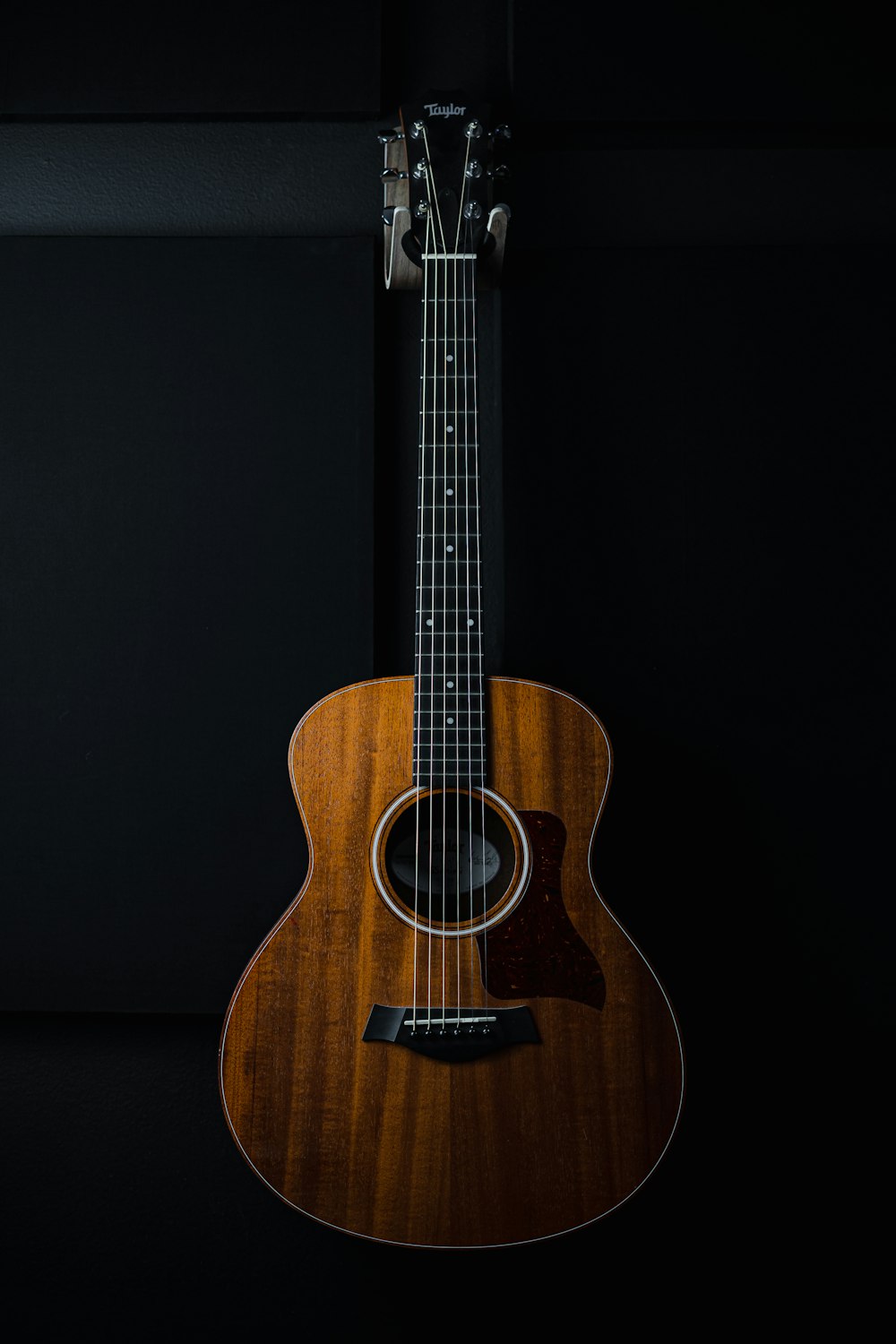 a close up of a guitar on a black background