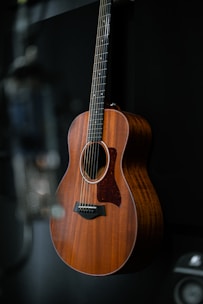 a guitar hanging on a wall in a room