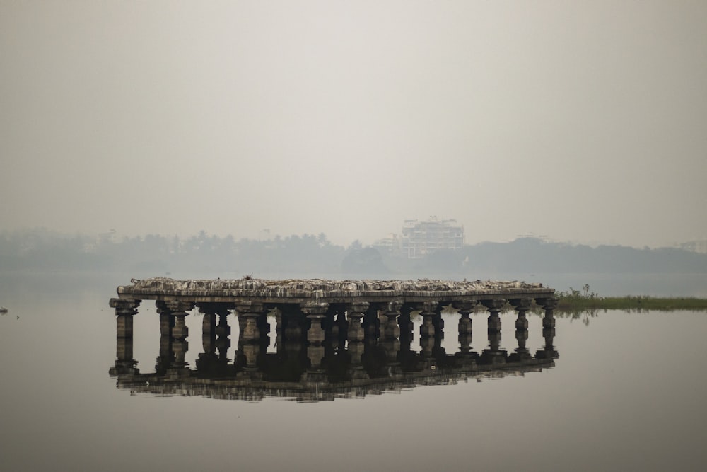 a large body of water with a pier in the middle of it