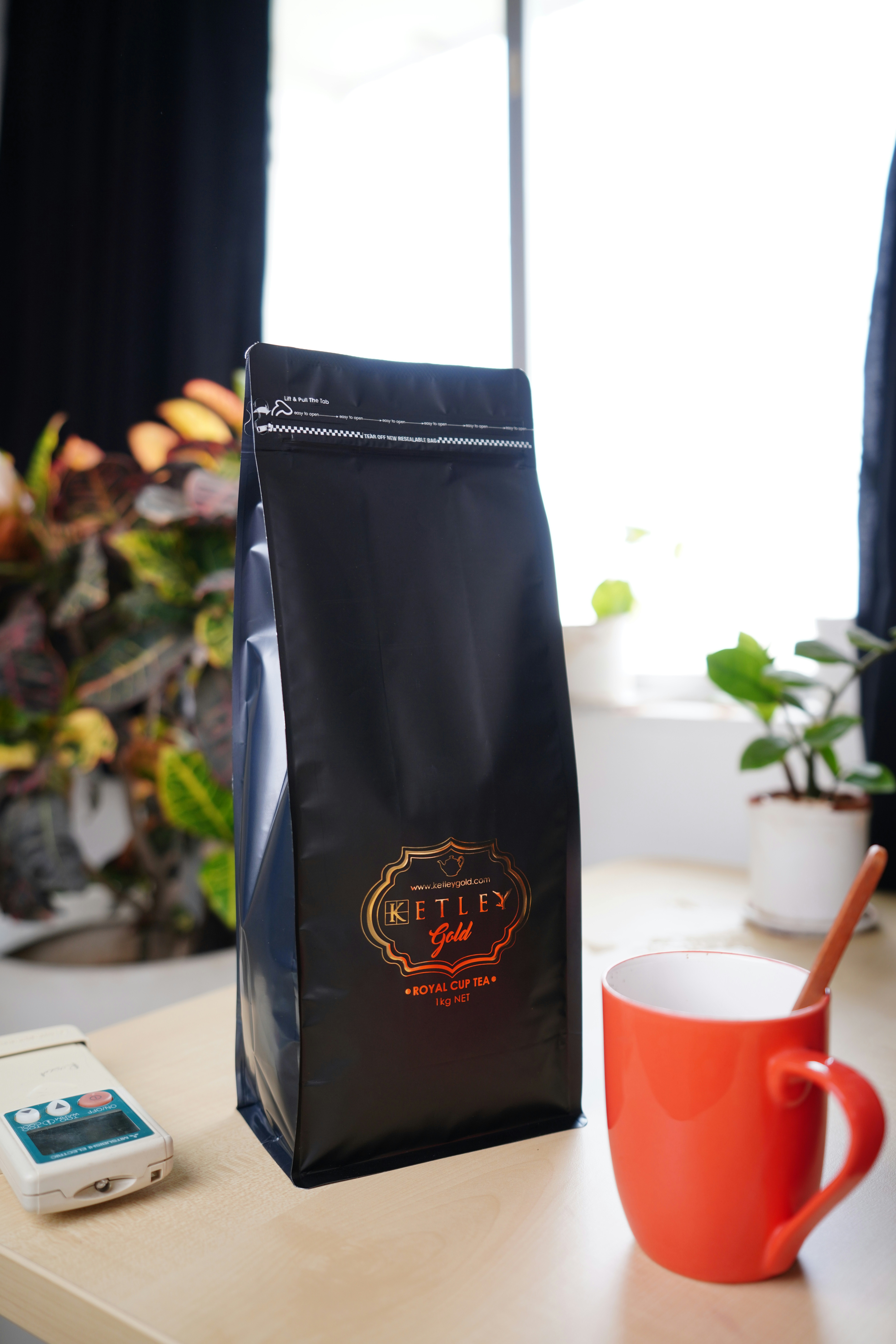 a coffee bag sitting on a table next to a cup