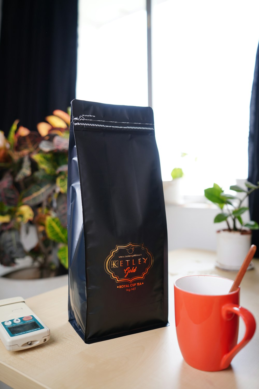 a coffee bag sitting on a table next to a cup