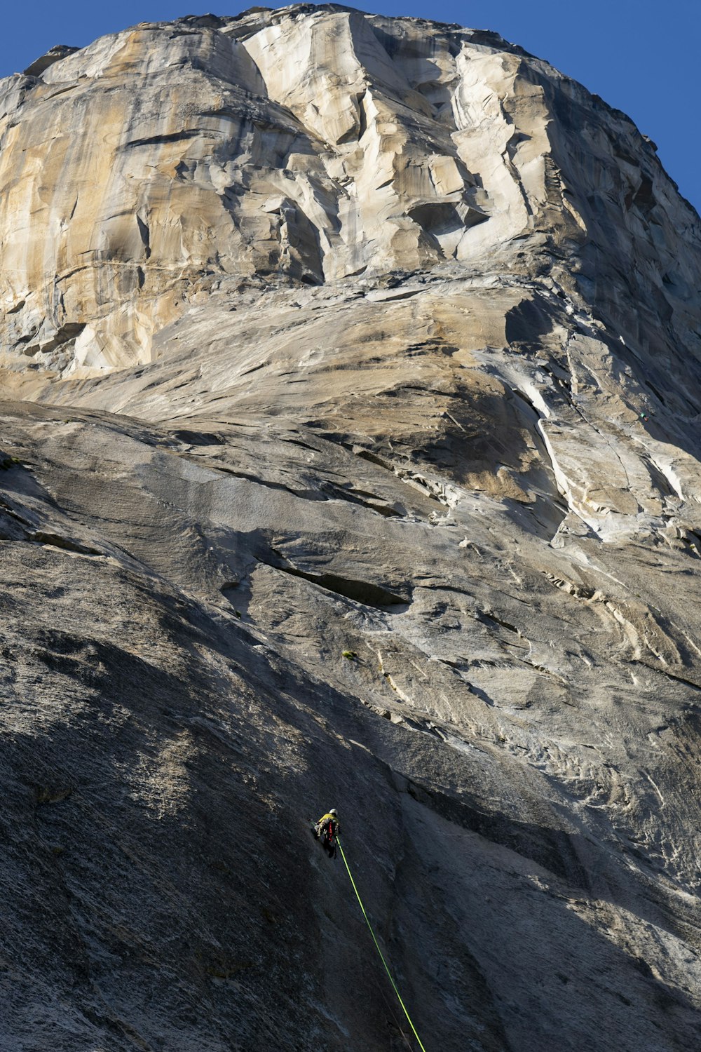 a man climbing up the side of a mountain