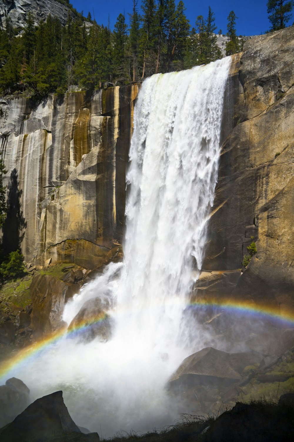 a waterfall with a rainbow in the middle of it