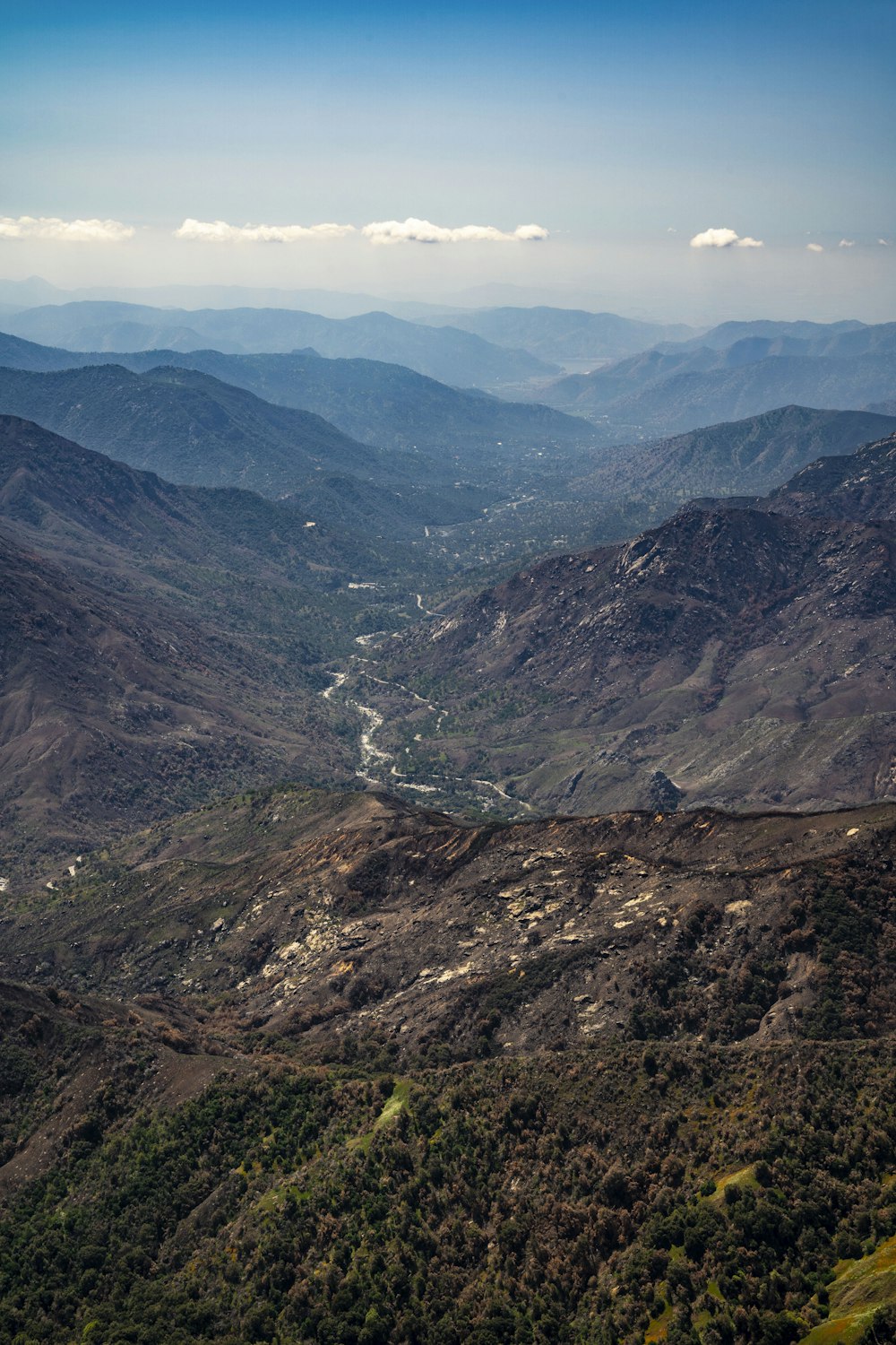 a scenic view of a valley and mountains