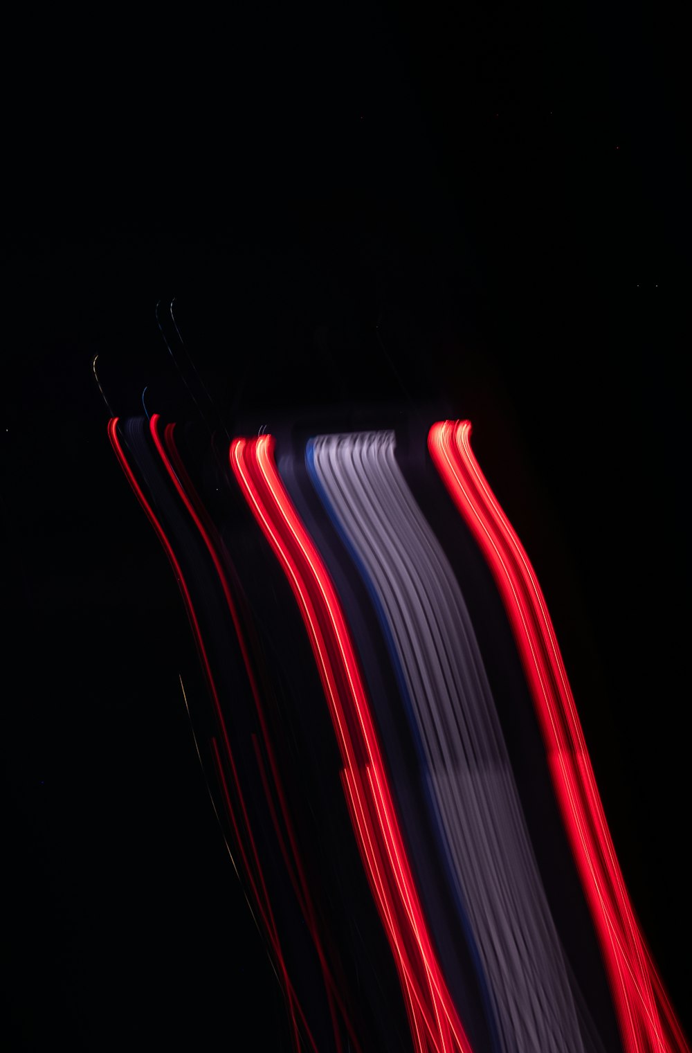 a blurry photo of a street sign with red, white and blue lights
