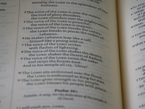 An open book with mystical symbols and numbers on its pages.