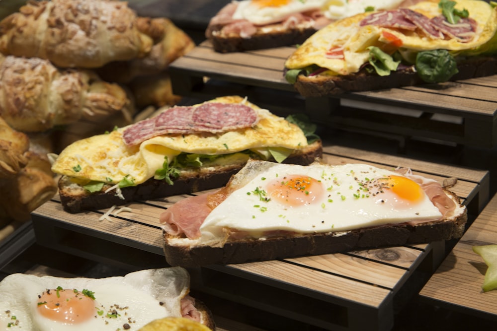 a bunch of different types of food on wooden trays