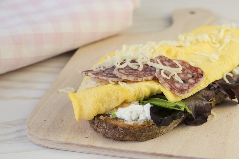 a close up of a sandwich on a cutting board