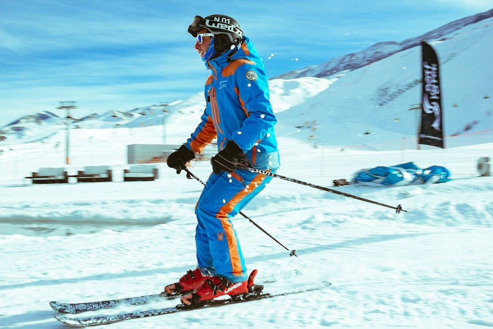 a man riding skis down a snow covered slope