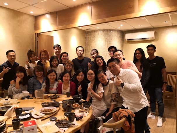 A warm family gathering around a table, sharing smiles and conversation in a cozy home setting.