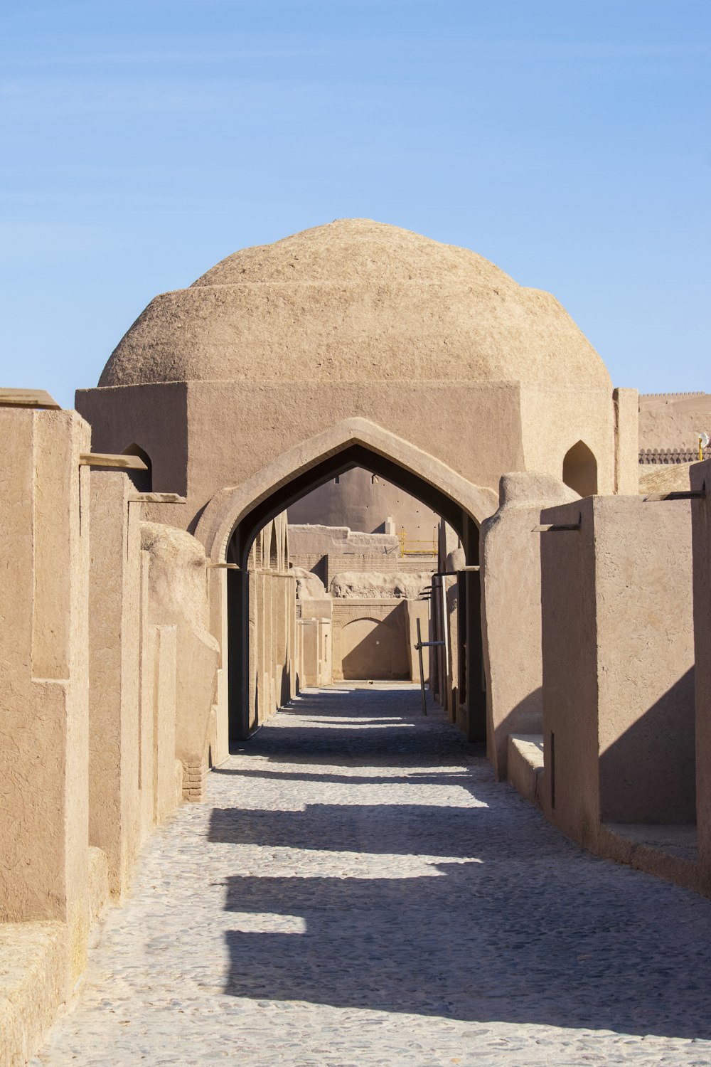 a walkway leading to a large stone building