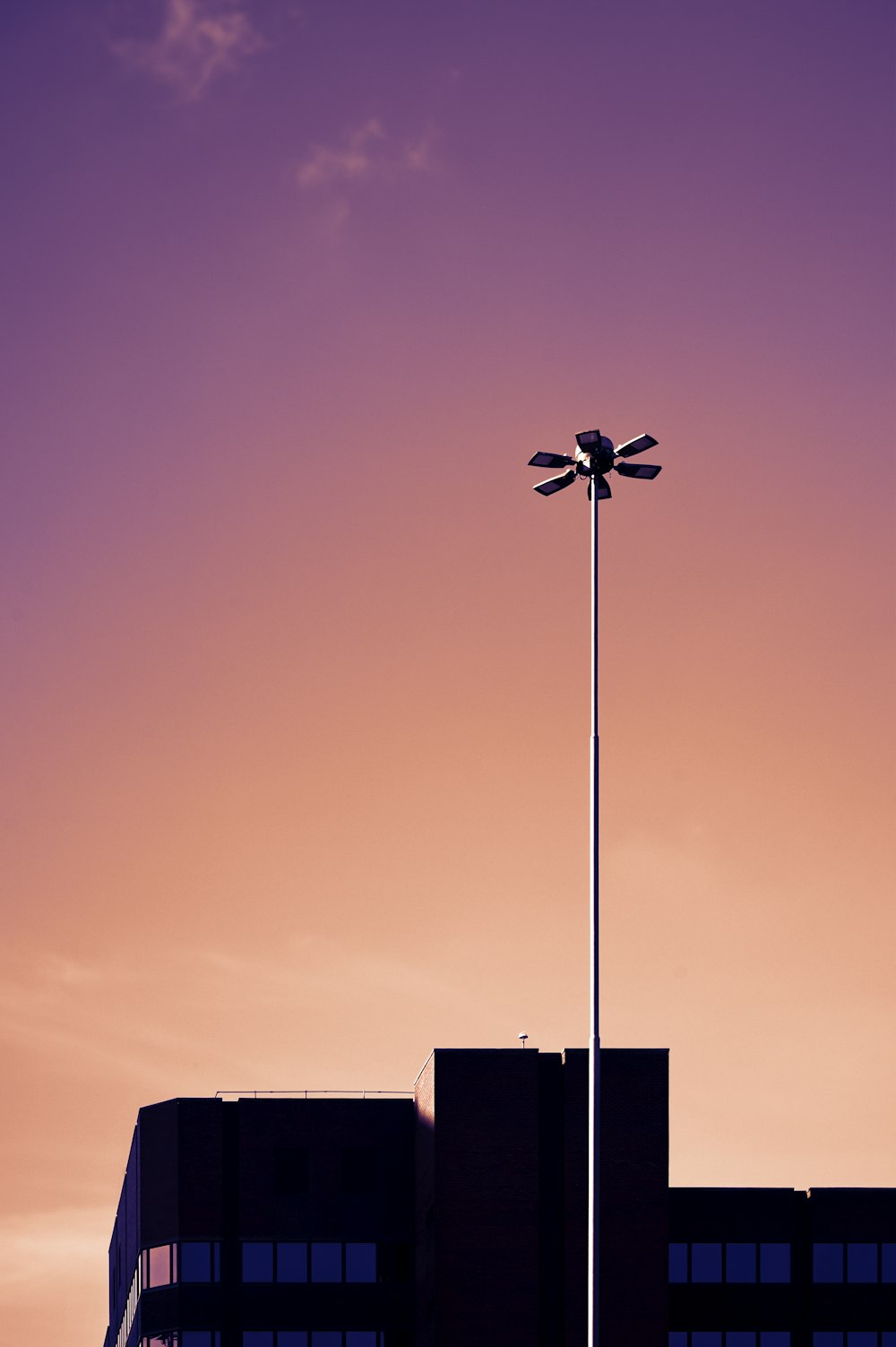 a street light with a building in the background