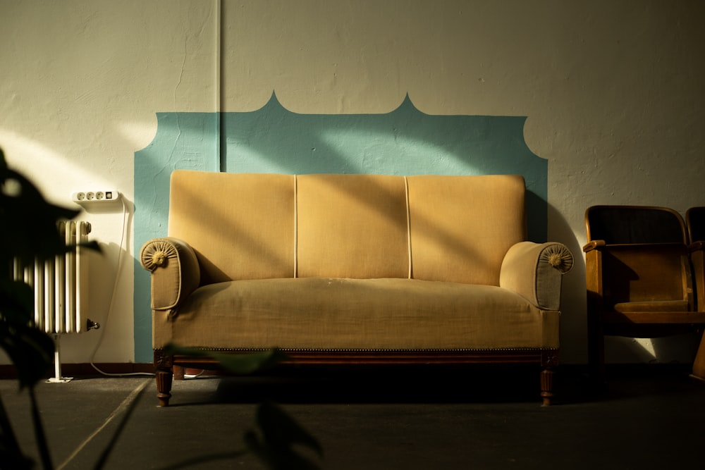 a couch sitting in a room next to a radiator