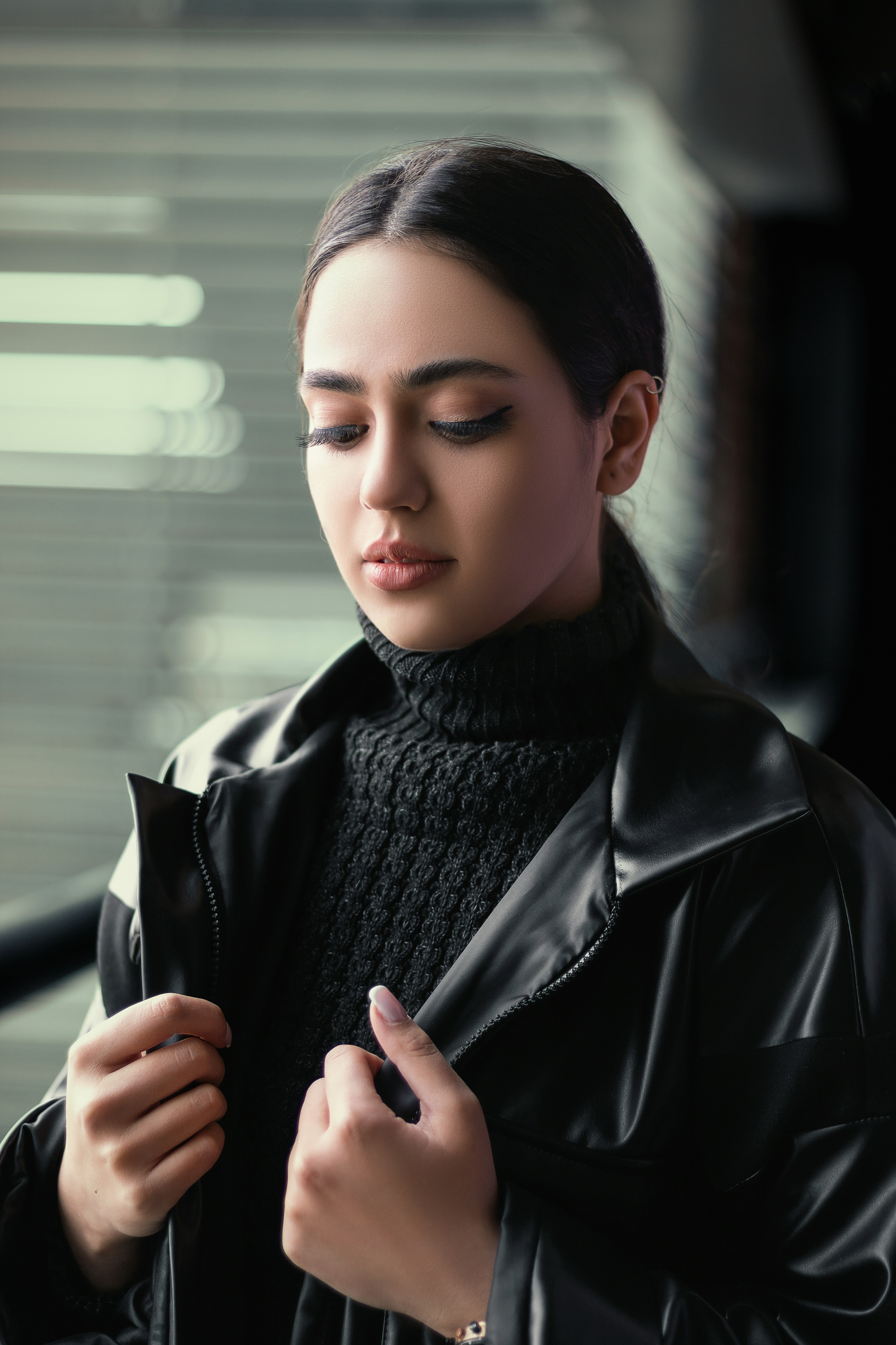 Woman styling a brooch on a jacket