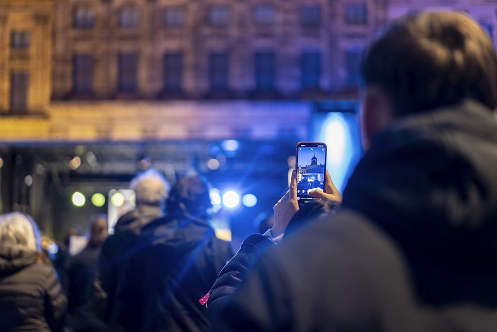 a person taking a picture of a building with a cell phone