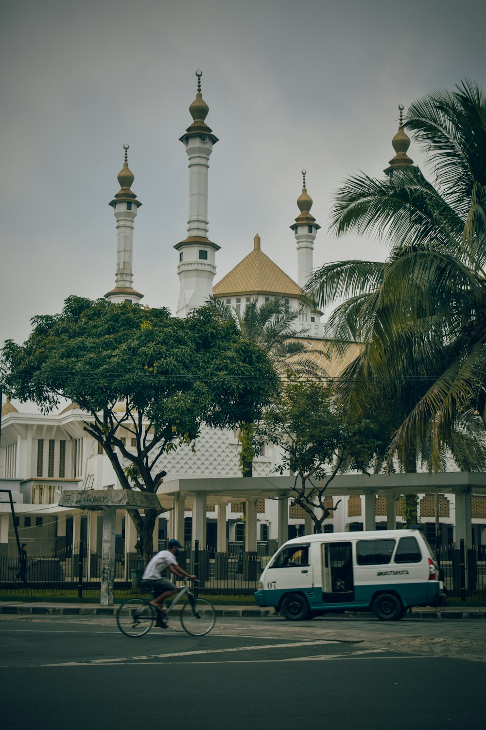 a person riding a bicycle in front of a building