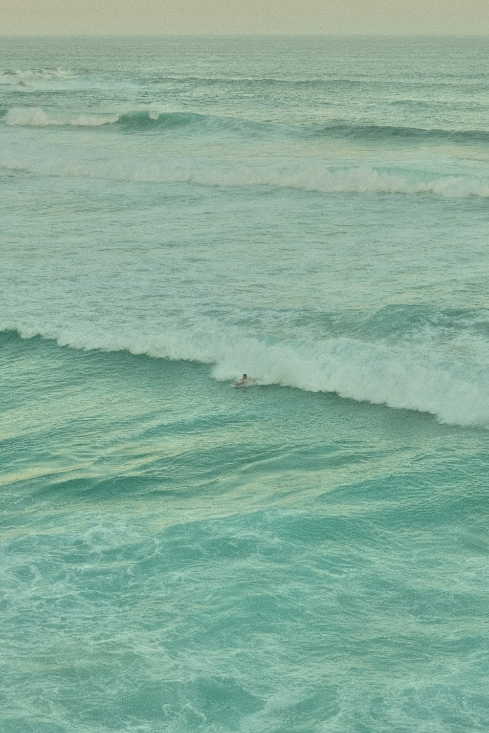 a man riding a wave on a surfboard in the ocean