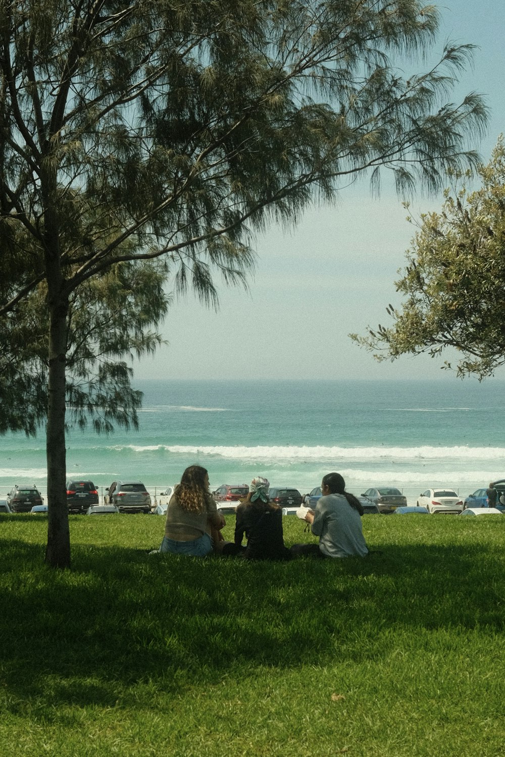 a group of people standing next to a body of water