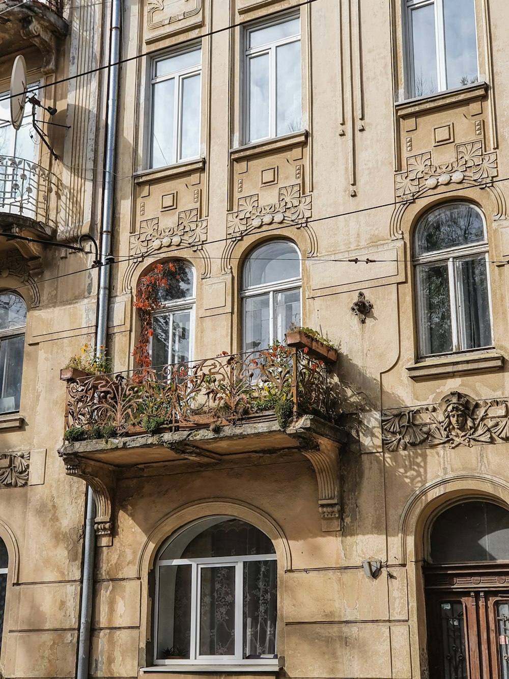 an old building with a balcony and flower boxes on the balconies