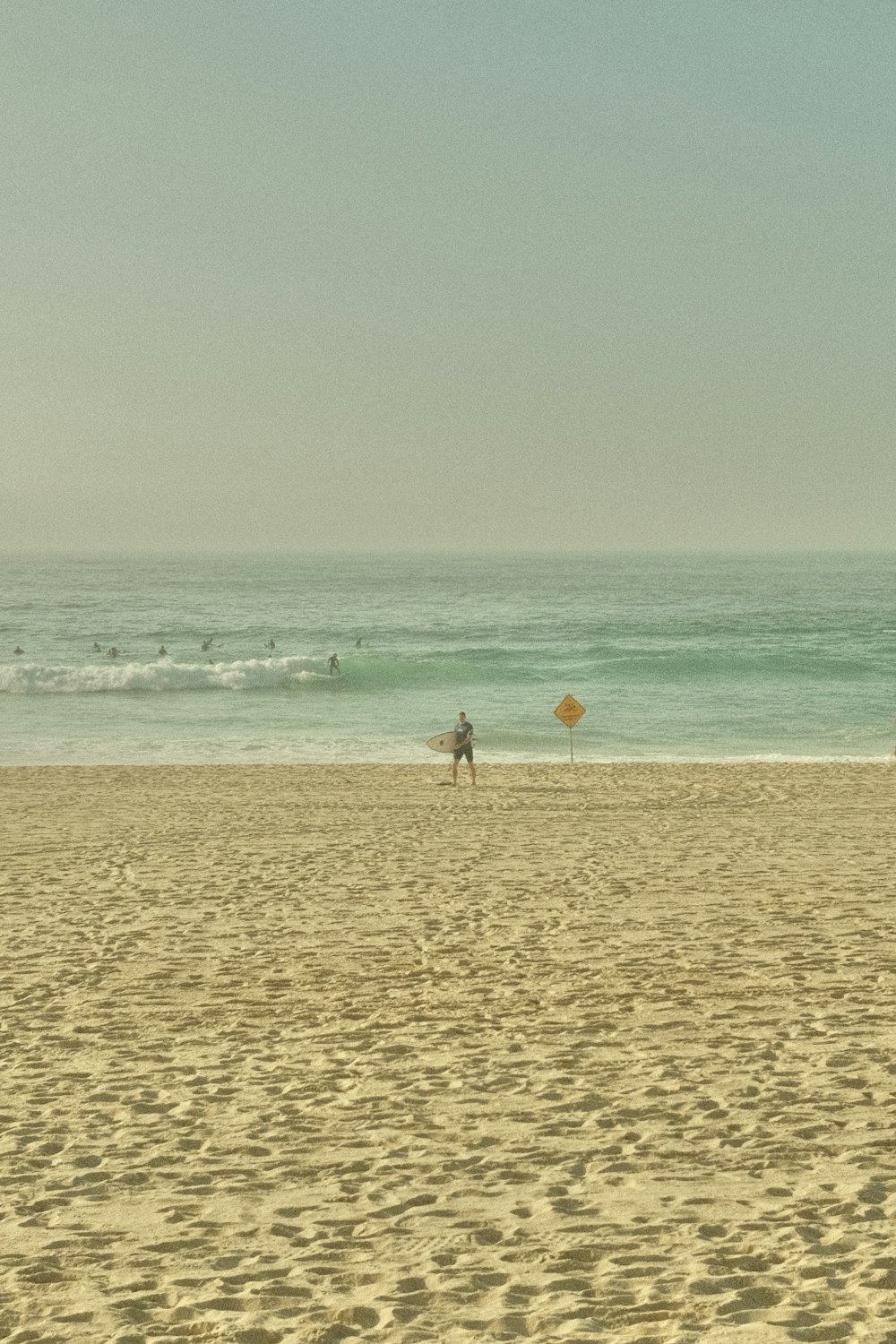 서핑 보드가있는 해변에 서있는 사람