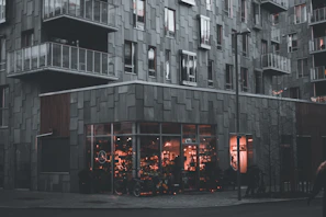 A renovated downtown apartment building with modern balconies and vibrant street life.