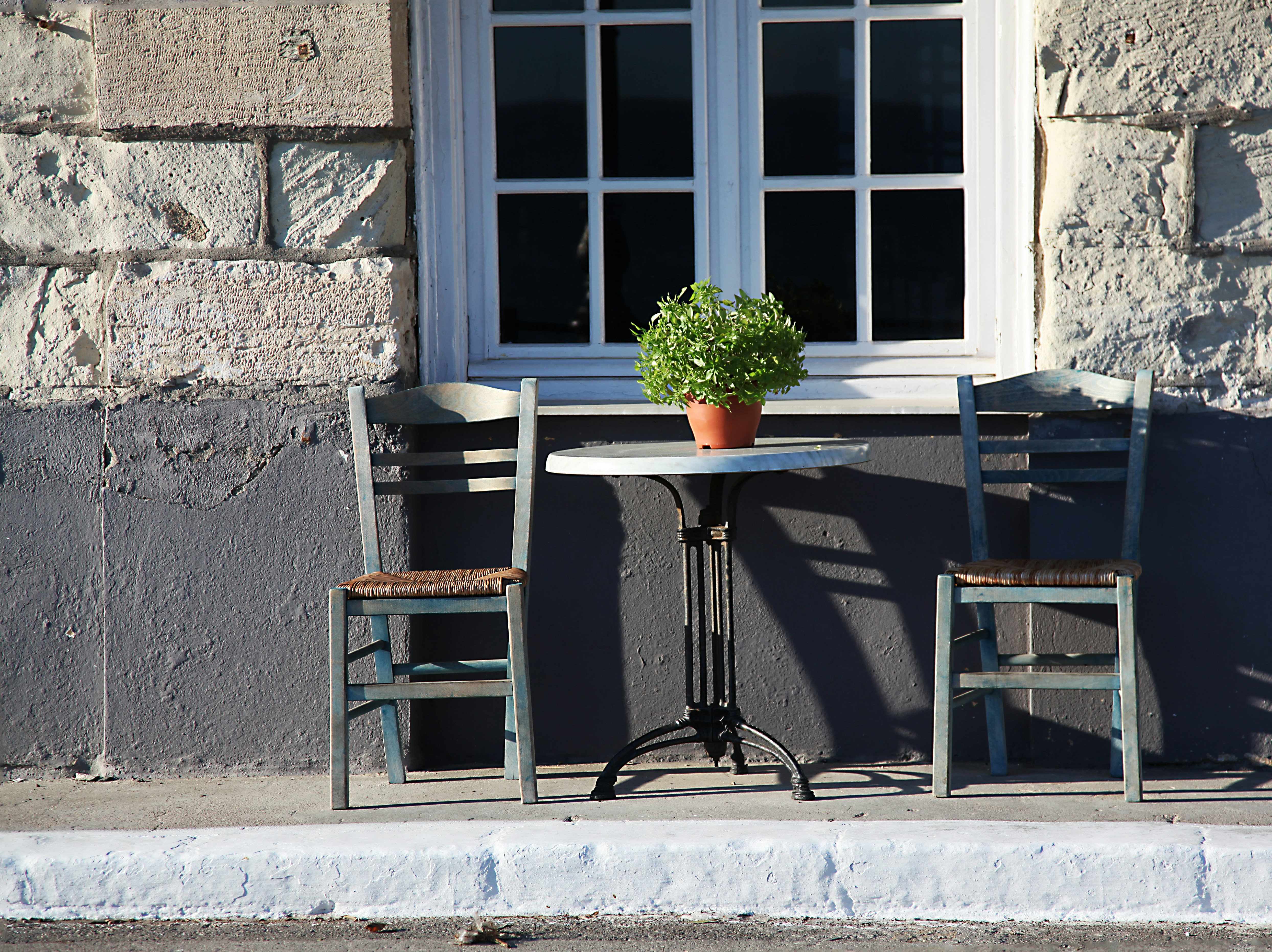 two chairs and a table in front of a window, 