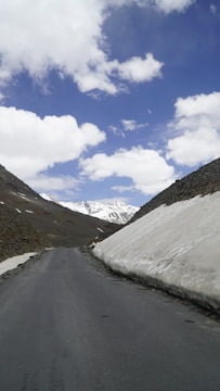 Mountain landscape with a winding road and clear blue sky.